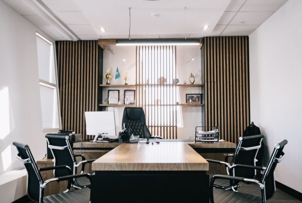 A browns carpet set amongst a stlysih office setting with four chairs.