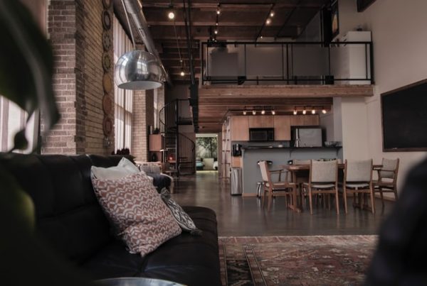 Black Sofa in Open Living room-diner, with brick interior