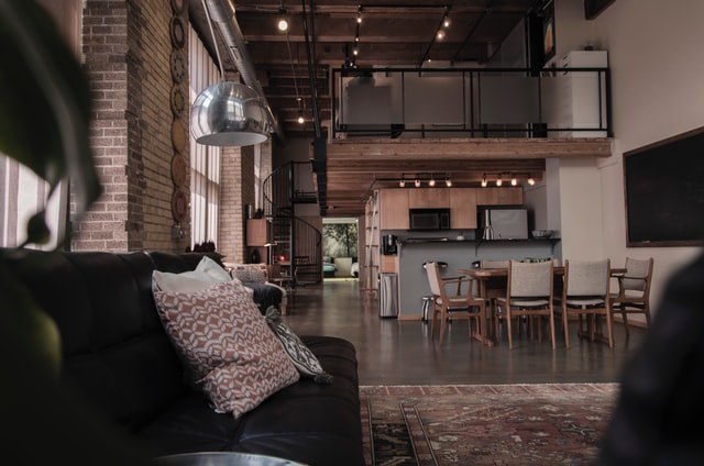 Black Sofa in Open Living room-diner, with brick interior
