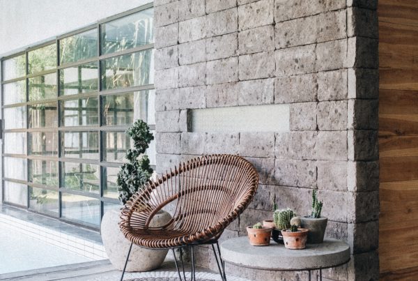 marble patio, with a white patterned rug and wooden chair on top