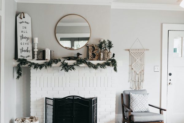 brown vinyl floor, with white walls and fireplace, decorated with a green wreath