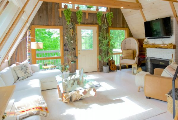 light room with cream carpets and light wooden beams